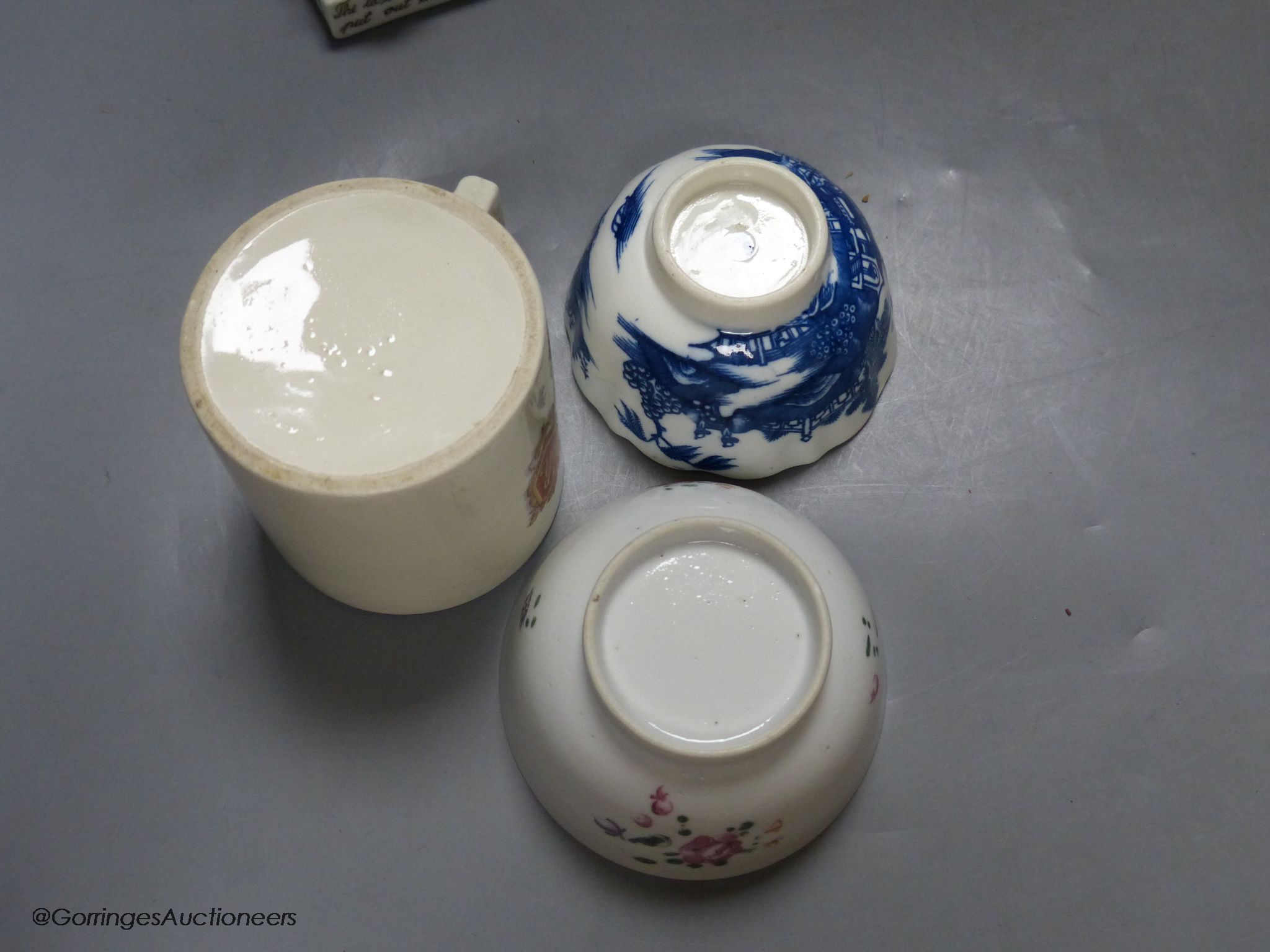 A German porcelain fairing - ' Last in bed', a famille rose tea bowl and three other pieces